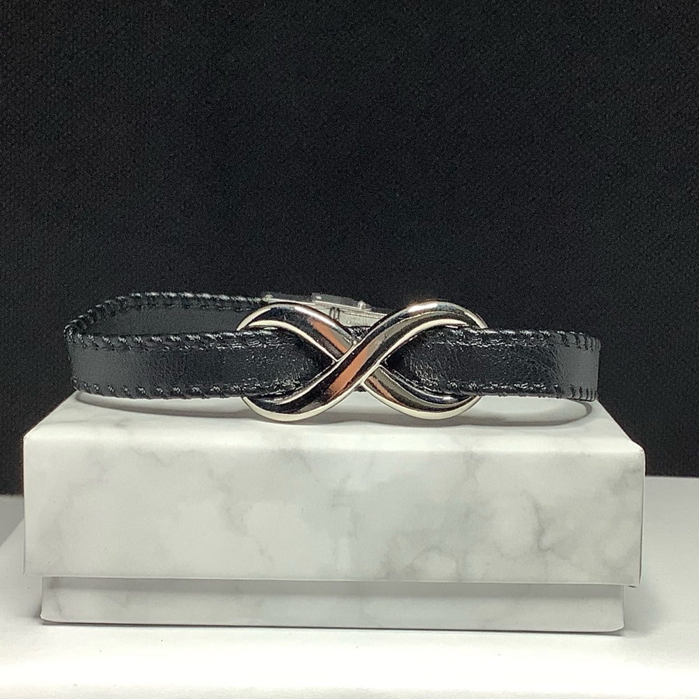 Faux leather band bracelet with stainless steel clasp and infinity symbol.